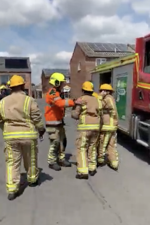 A student in firefighting equipment being put through a training drill